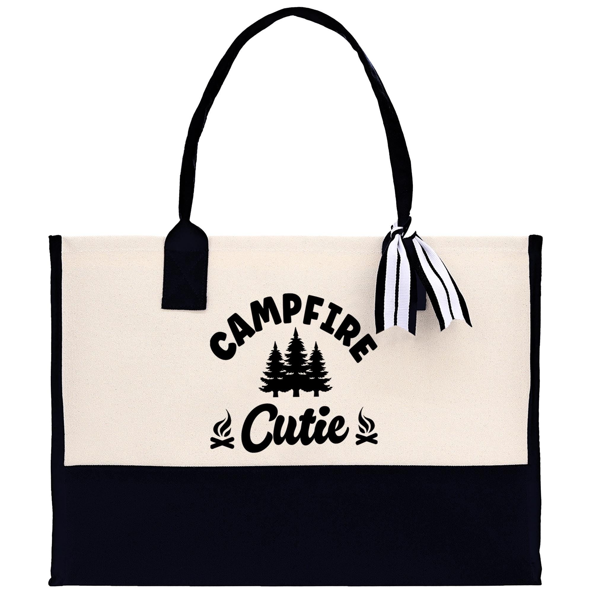 A black and white tote bag with the text "Campfire Cutie" printed on it.