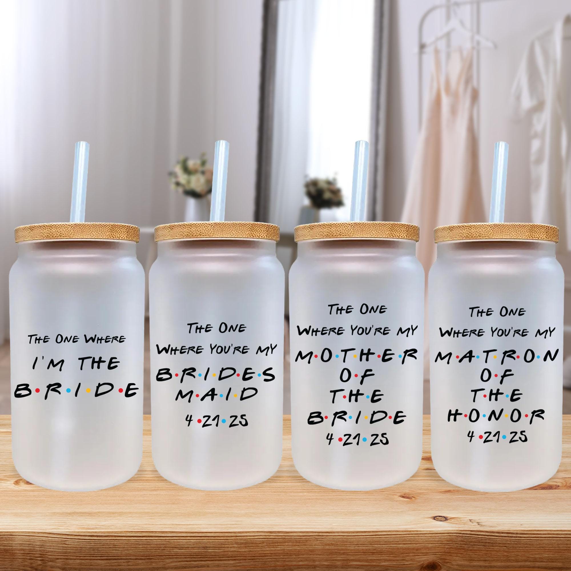 a group of three water bottles sitting on top of a wooden table