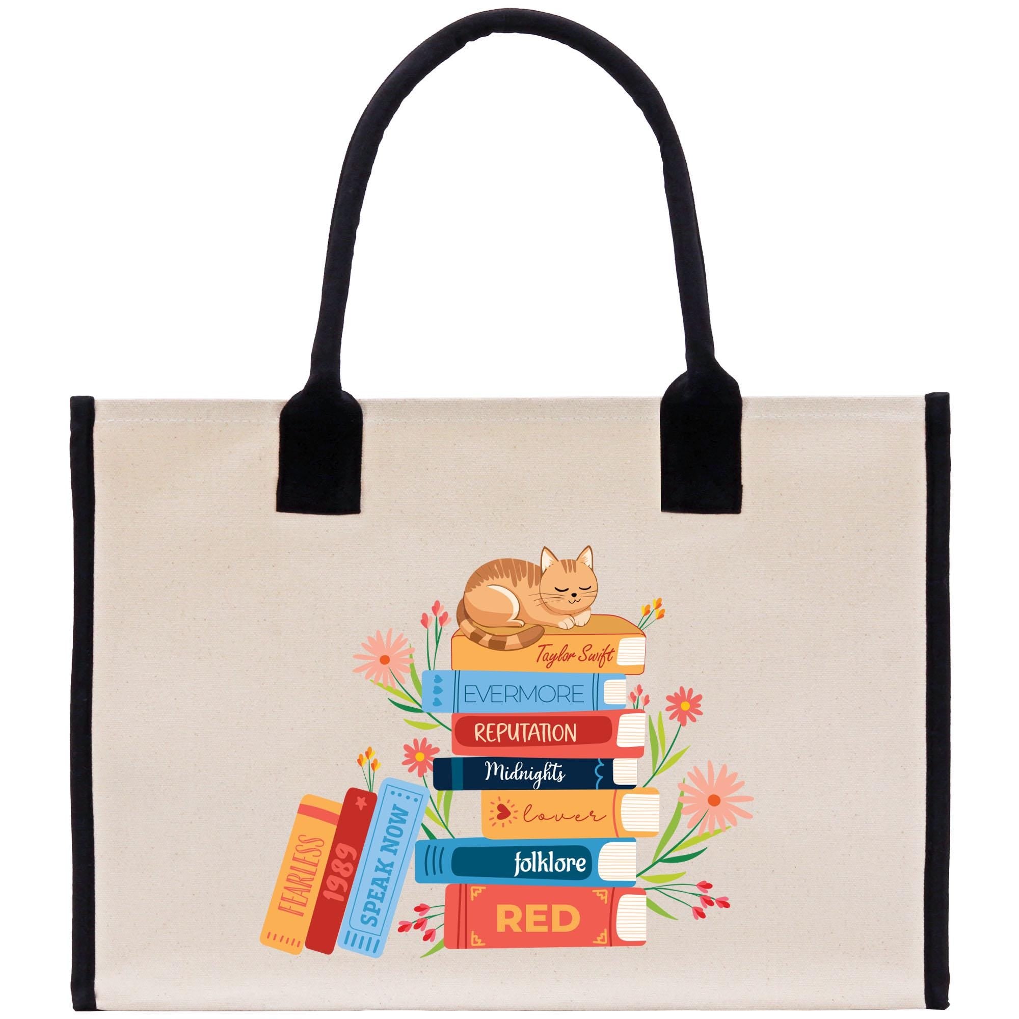 A tote bag with a stack of colorful books and a cat on top, surrounded by flowers.