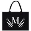 A black paper bag with a white monogrammed letter "M" and leaf-like designs on the front.