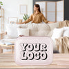 A woman is standing in a living room, with a white leather case featuring the text "YOUR LOGO" in the foreground.