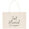 A beige canvas tote bag with the text "Just Married Susan & Matthew 07.28.25" printed on it.