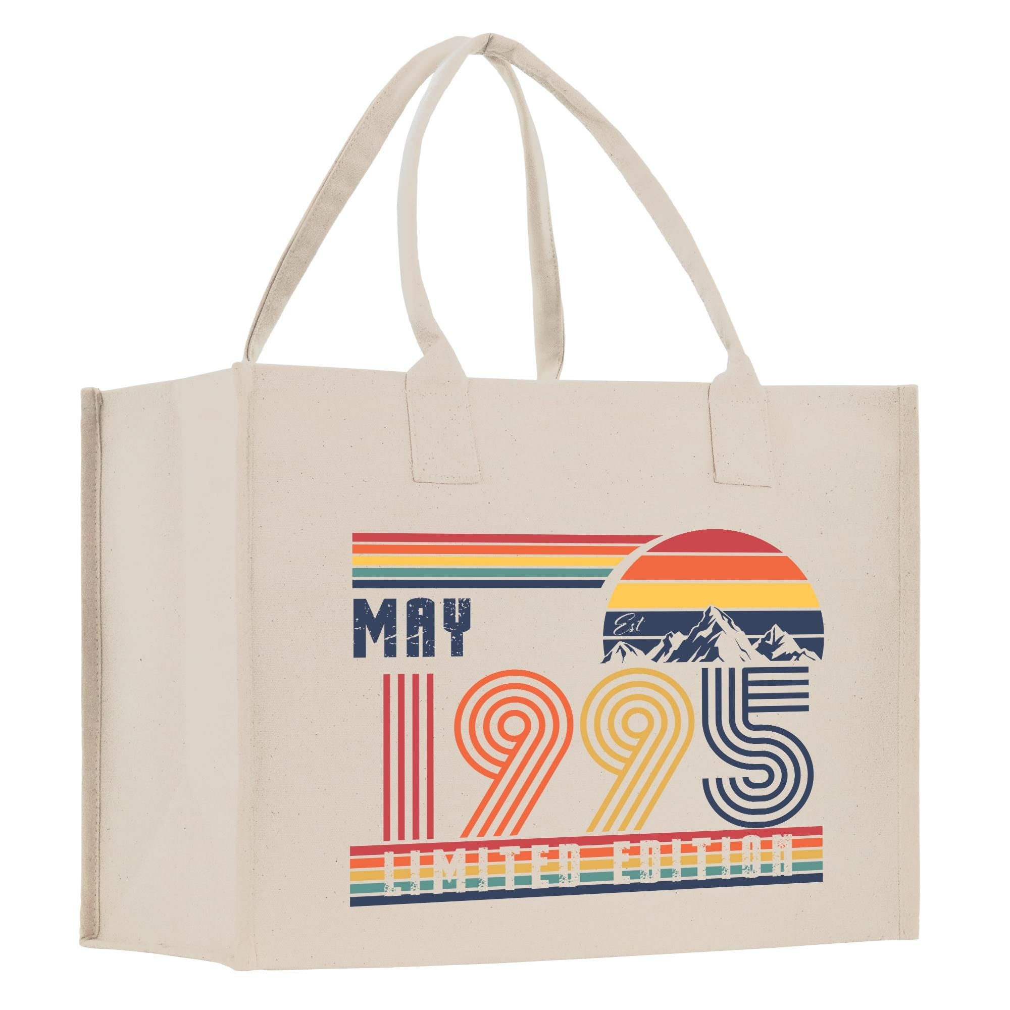 A beige canvas tote bag with a graphic design featuring a sunset, mountains, and the text "MAY 1995" and "LIMITED EDITION".