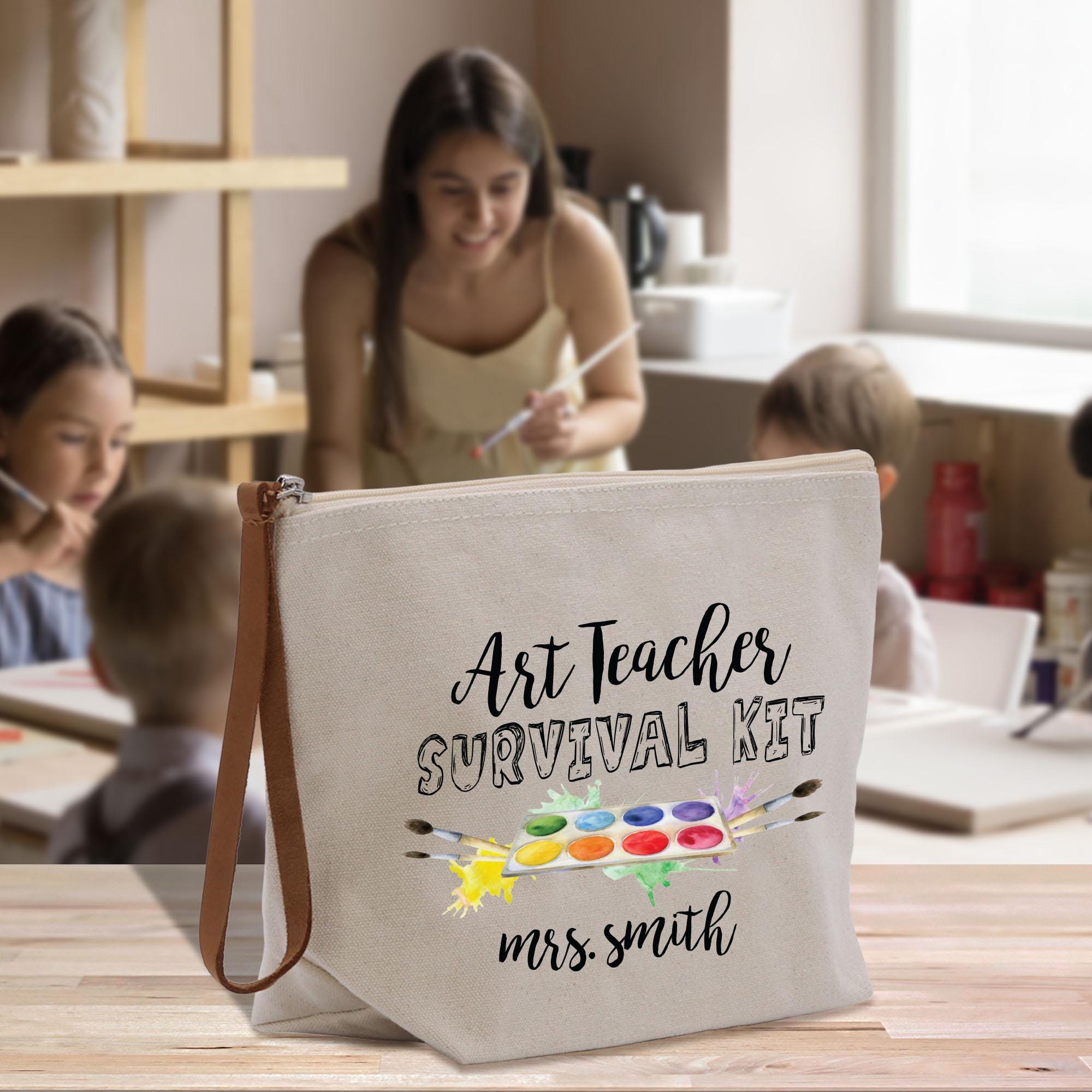 a canvas bag with the words art teacher survival kit on it