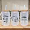 Three mason jar tumblers with personalized names and designs on them, placed on a wooden surface.