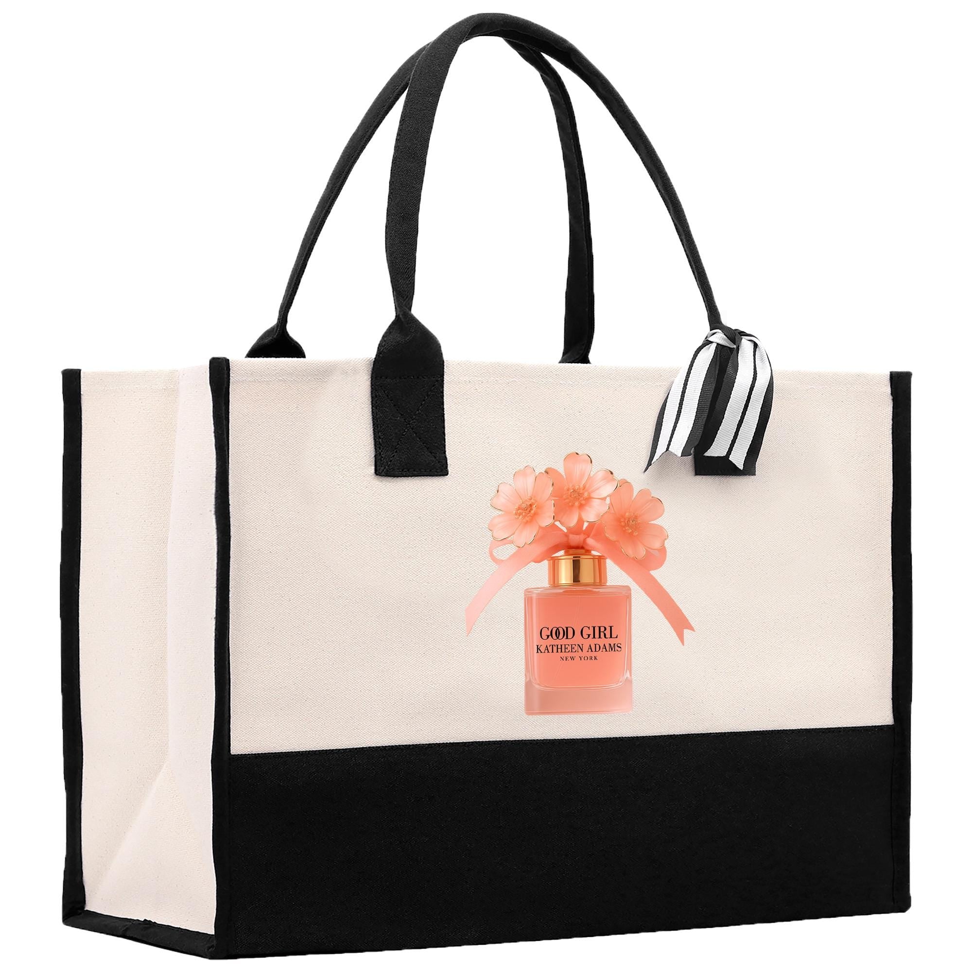 A black and white tote bag with a printed image of a perfume bottle and flowers on it.