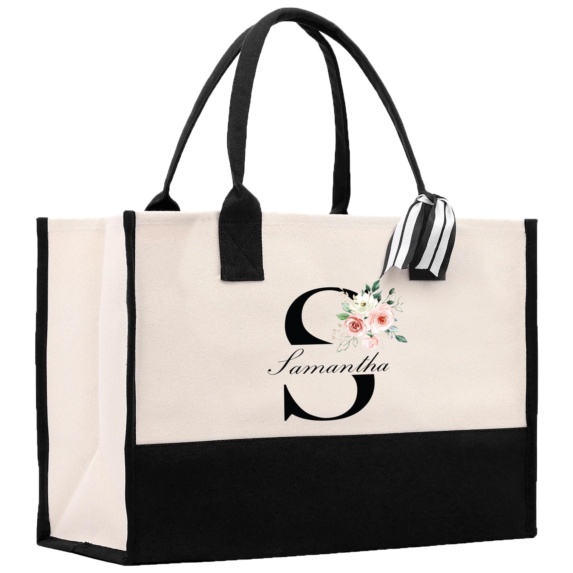 a black and white bag with a flower on it