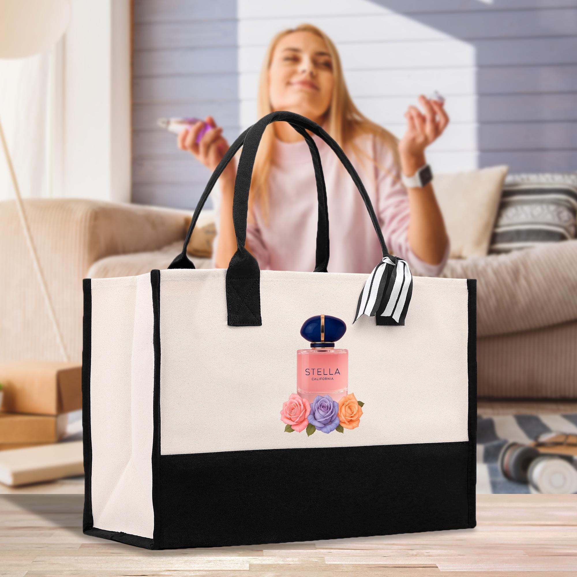 A woman is sitting on a couch, holding a phone, and a large tote bag with a perfume bottle design is placed in front of her.