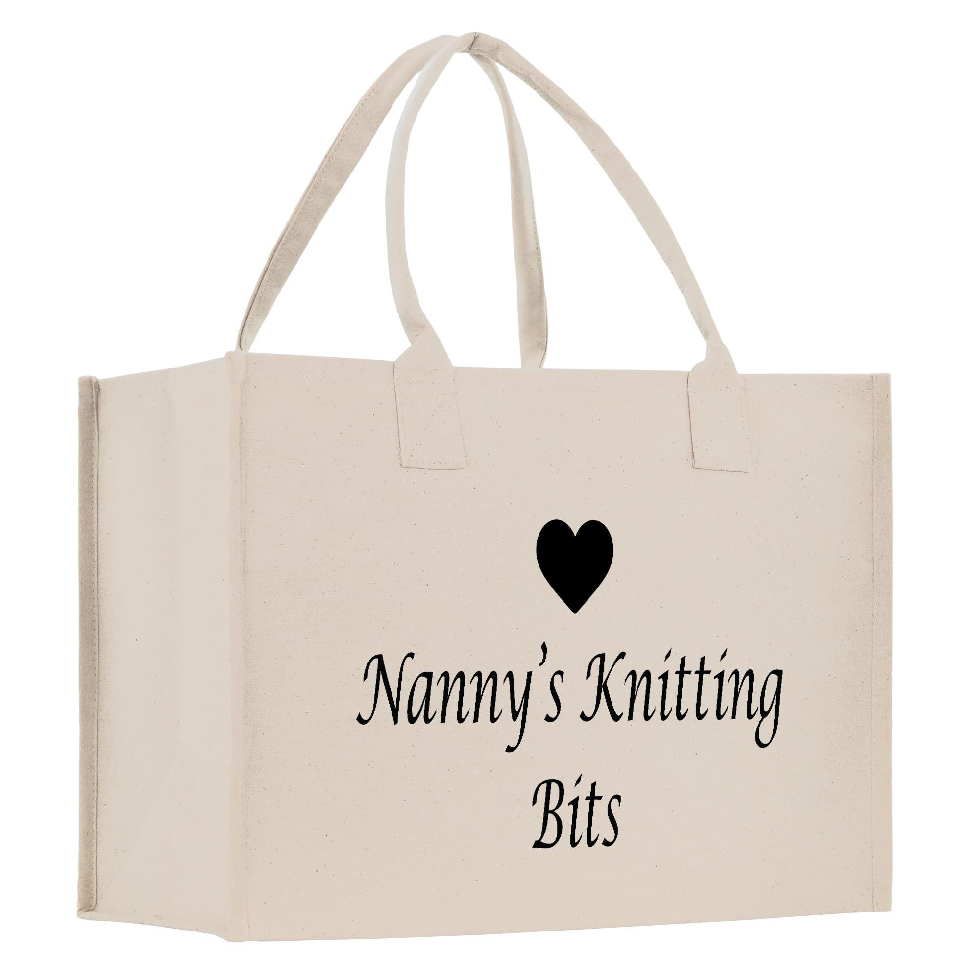 A beige canvas tote bag with the text &quot;Nanny&#39;s Knitting Bits&quot; printed on it.