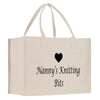 A beige canvas tote bag with the text "Nanny's Knitting Bits" printed on it.