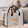 a woman sitting on a couch next to a woman holding a bag