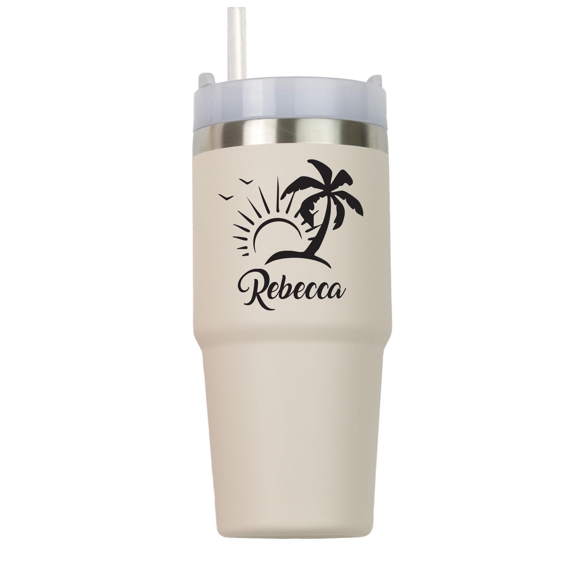 a white tumbler cup with a palm tree on it