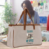 a woman holding a bag with a sewing machine on it