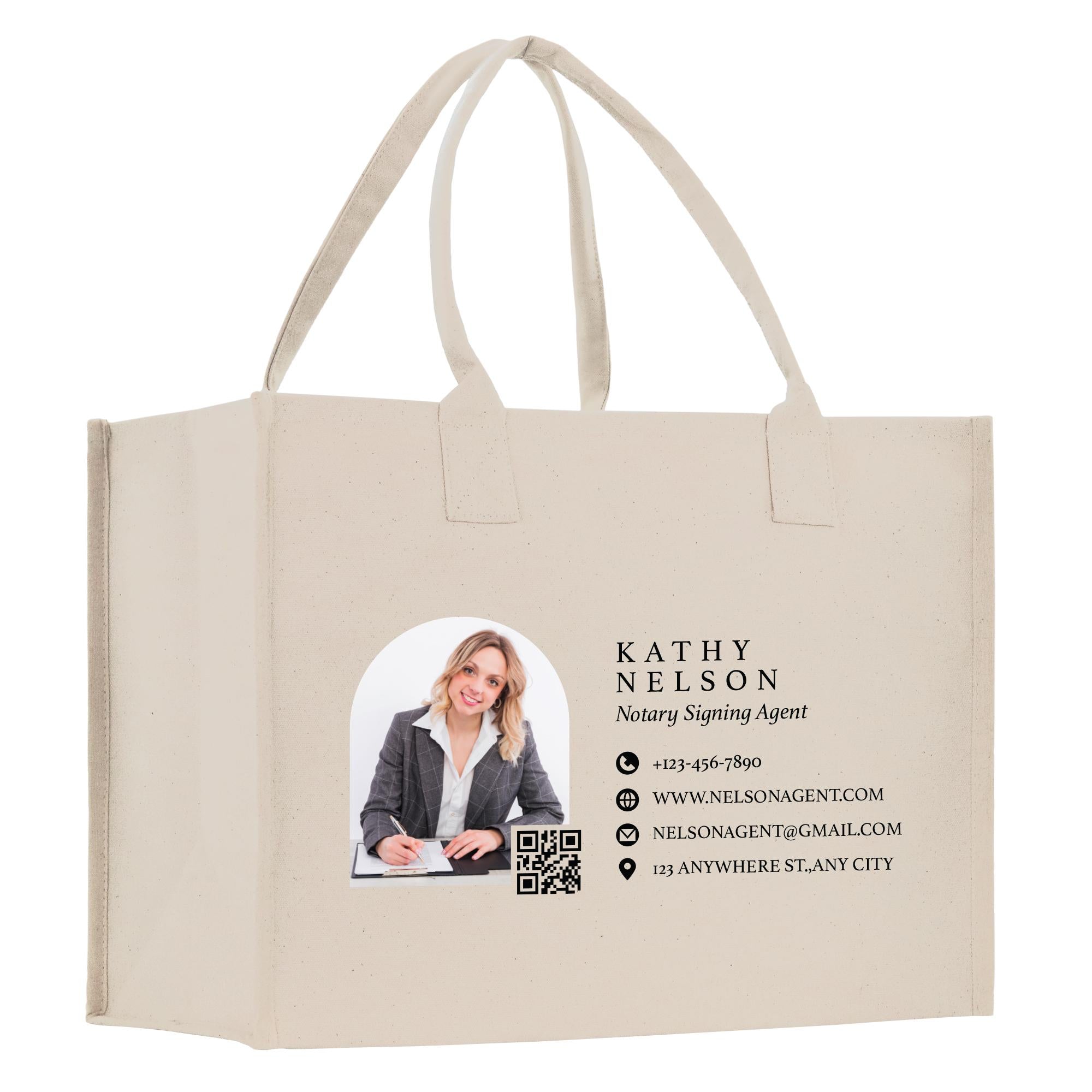 A beige tote bag with a printed image of a smiling woman and contact information for Kathy Nelson, a Notary Signing Agent.