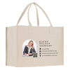 A beige tote bag with a printed image of a smiling woman and contact information for Kathy Nelson, a Notary Signing Agent.