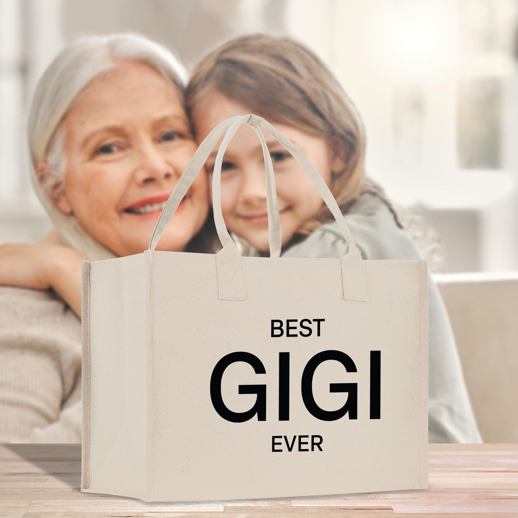 an older woman and a young girl holding a bag that says best gig ever