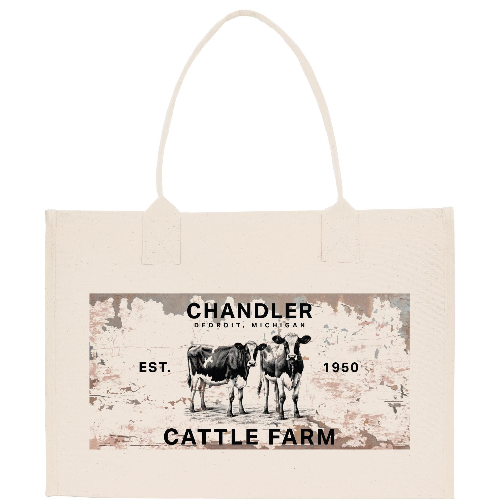 a beige canvas tote bag with a printed design on it. The design includes a vintage-style illustration of two cows, along with text that reads &quot;CHANDLER, DETROIT, MICHIGAN, EST. 1950, CATTLE FARM&quot;.