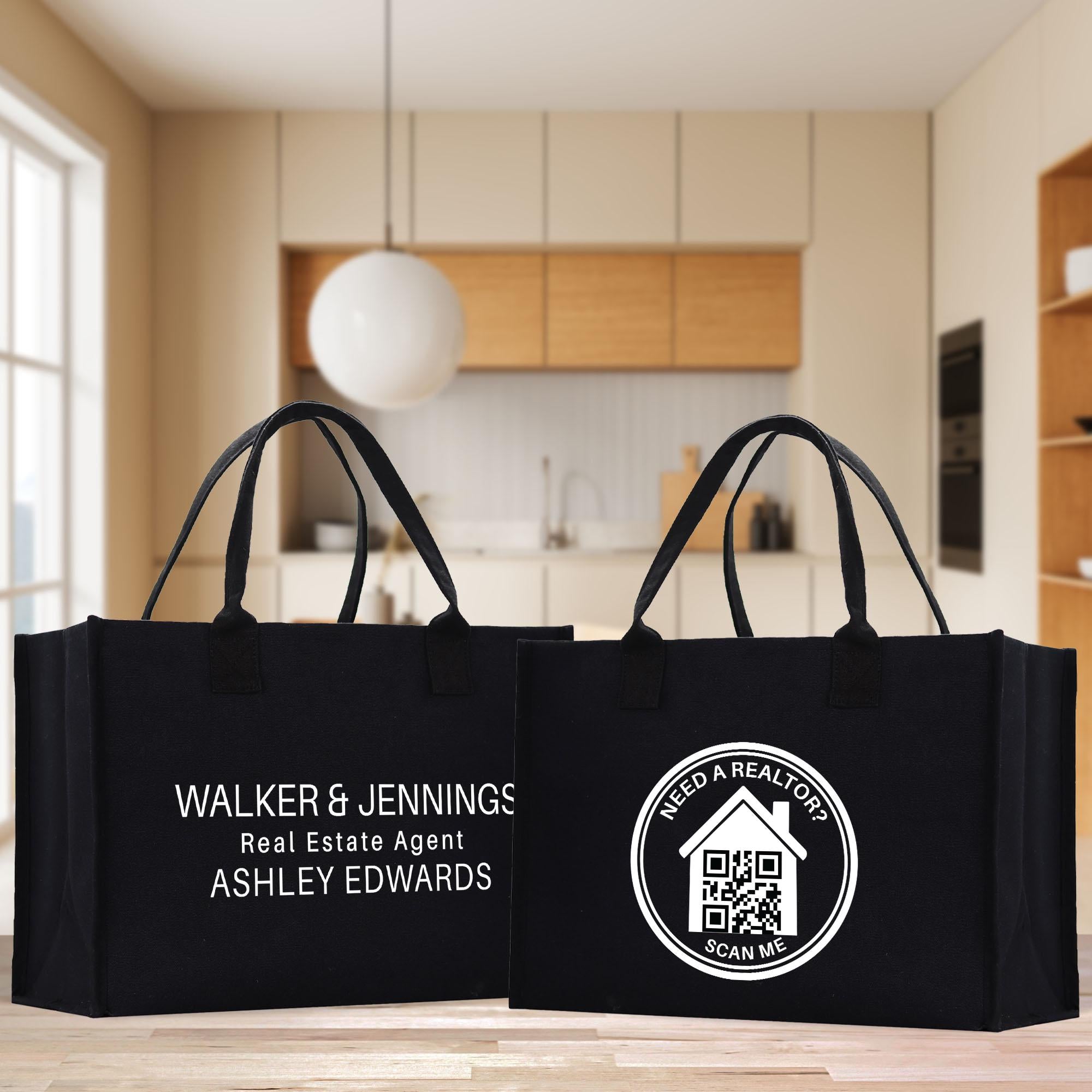Two black tote bags with text and logos printed on them, placed on a wooden surface in a room with a kitchen visible in the background.