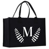 A black tote bag with a white monogrammed letter "M" on it.