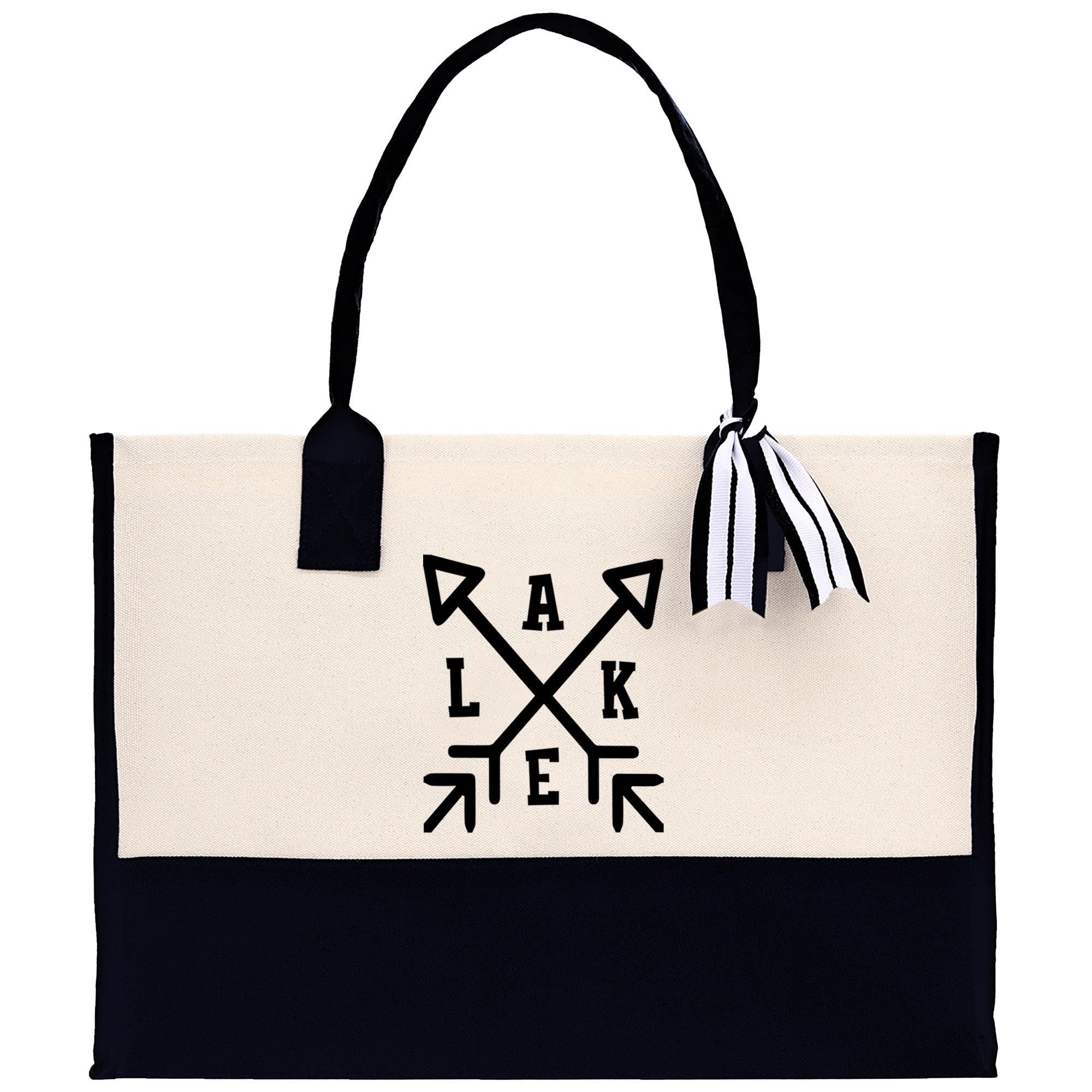 A black and white tote bag with a graphic design on the front.