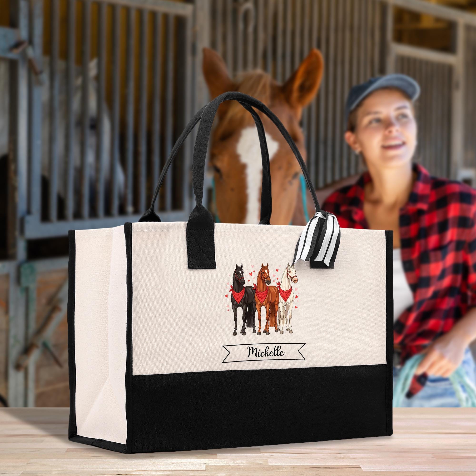 a woman sitting in front of a bag with horses on it