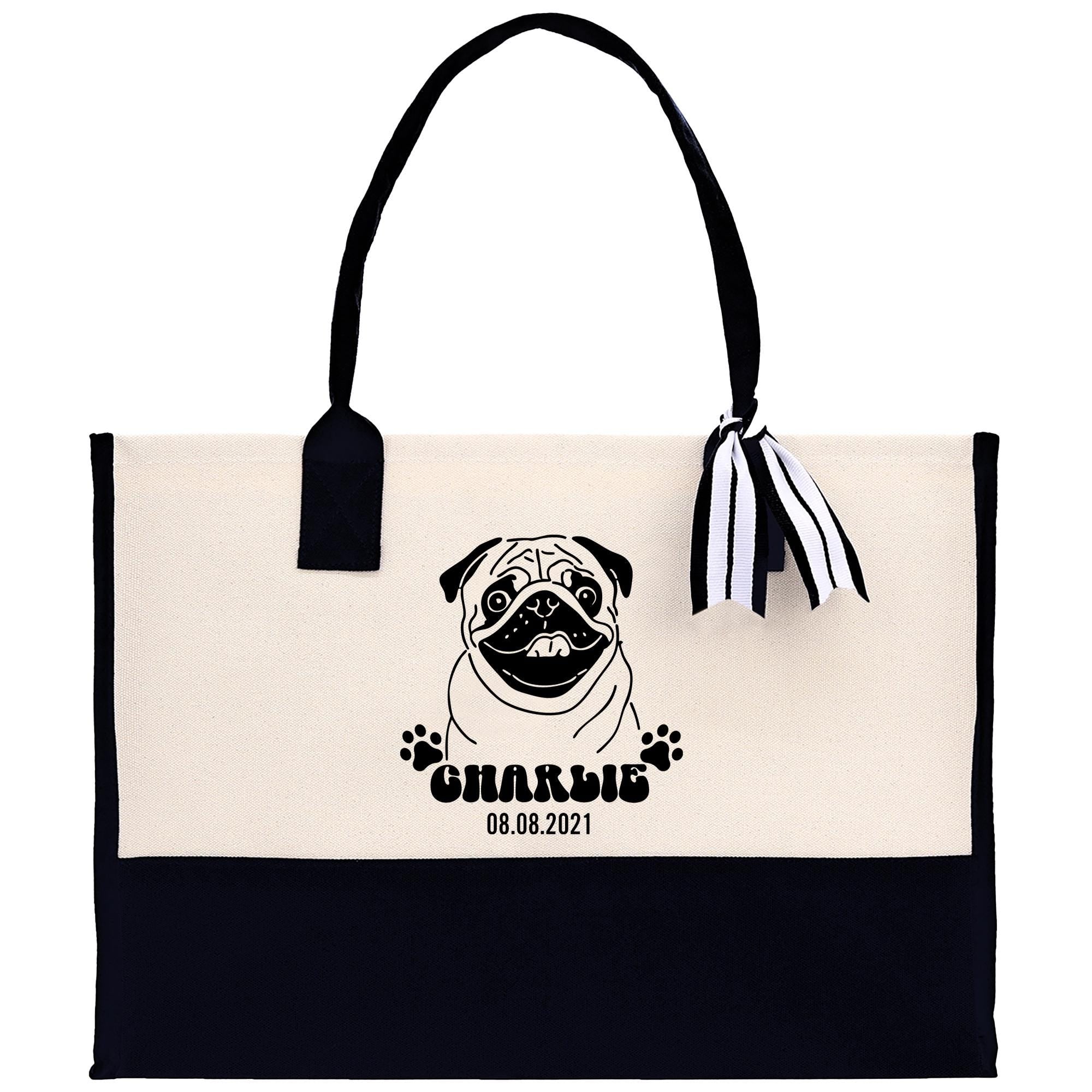 A tote bag with a pug dog design and a ribbon attached to it.
