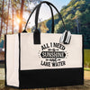 A black and white tote bag with a printed phrase on it, placed on a wooden surface with a natural outdoor background.