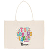 A beige canvas tote bag with a colorful, hand-drawn design featuring the text "Tiny Women's Time" surrounded by various decorative elements.