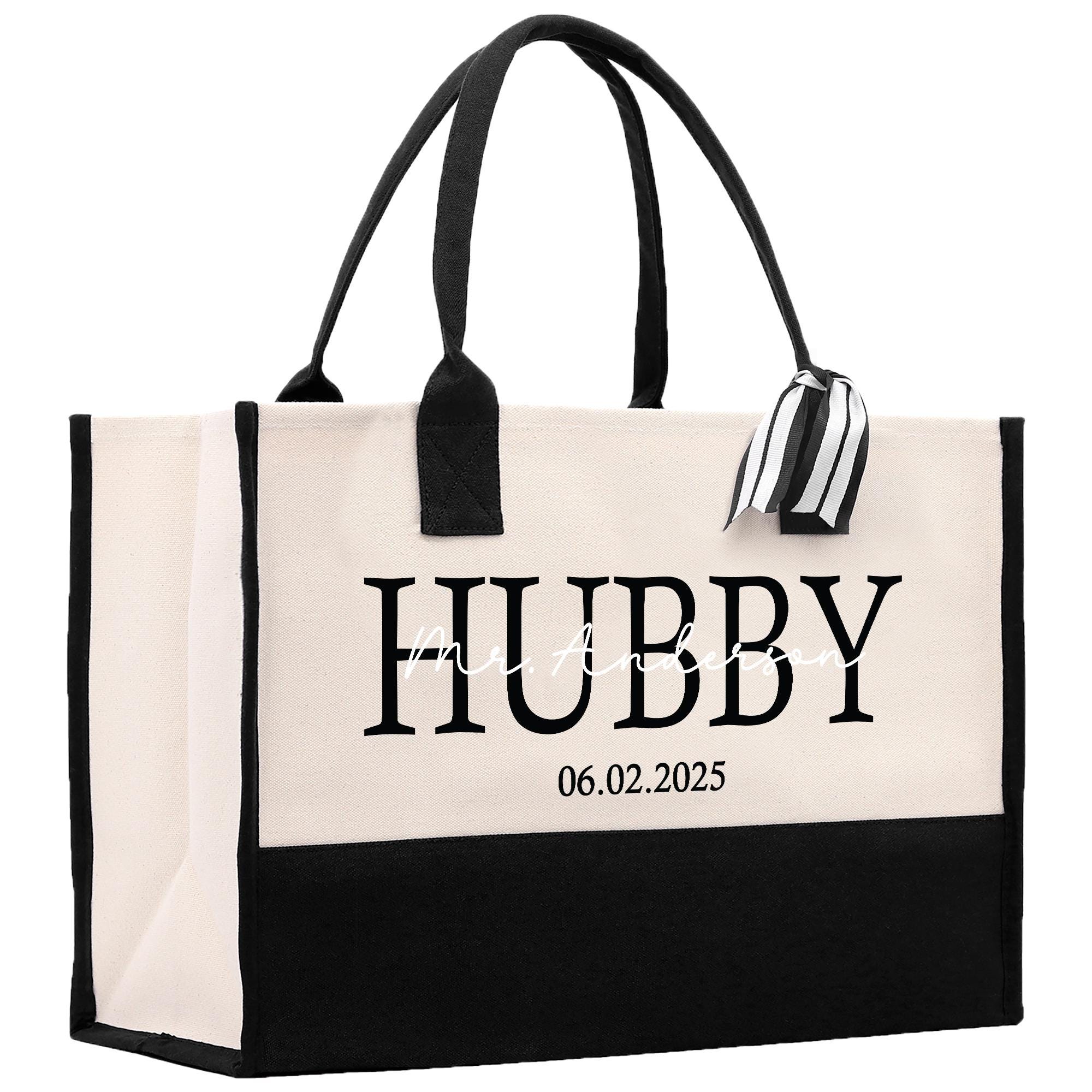 a black and white tote bag with a name tag
