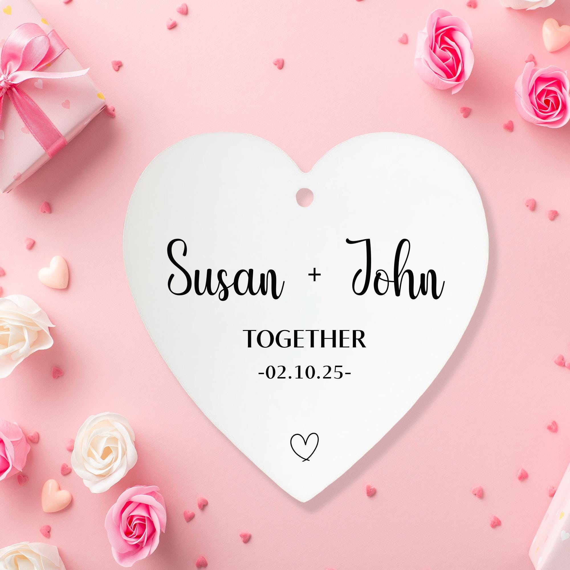 a white heart shaped paper with a couple&#39;s name on it