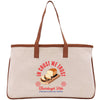 A beige tote bag with a graphic design featuring a loaf of bread and the text "In trust we trust" printed on it.