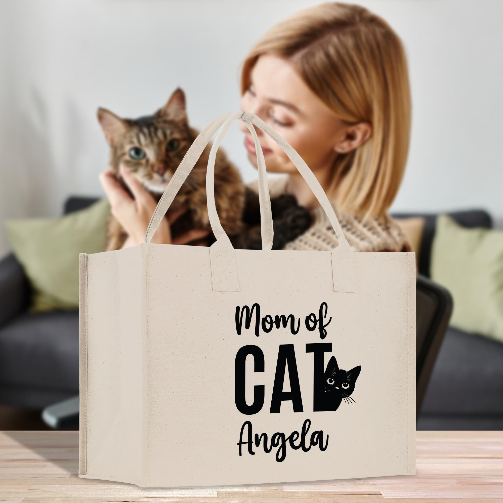 a woman is holding a cat in a bag
