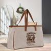 a canvas tote bag with a brown leather handle