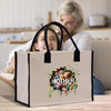 a woman sitting on a couch next to a woman holding a bag