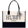 a black and white tote bag with a name tag