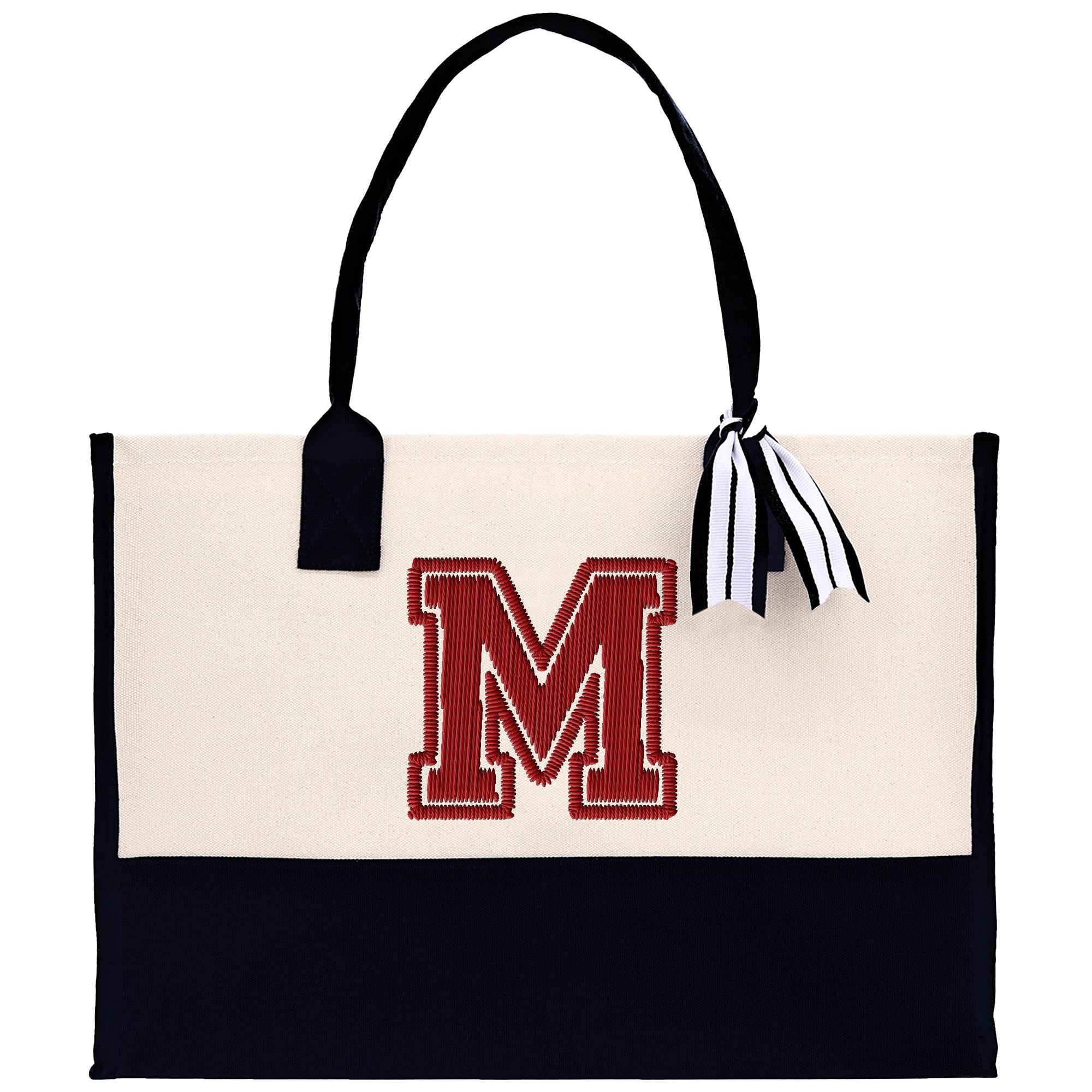 A beige tote bag with a black handle and a red embroidered letter &quot;M&quot; on the front.