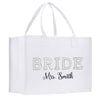 A white tote bag with the text "BRIDE" and "Mrs. Smith" printed on it.