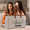 two girls sitting on a couch looking at a bag