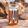 A glass jar filled with a brown liquid, with the word "DAD" printed on it in white letters.
