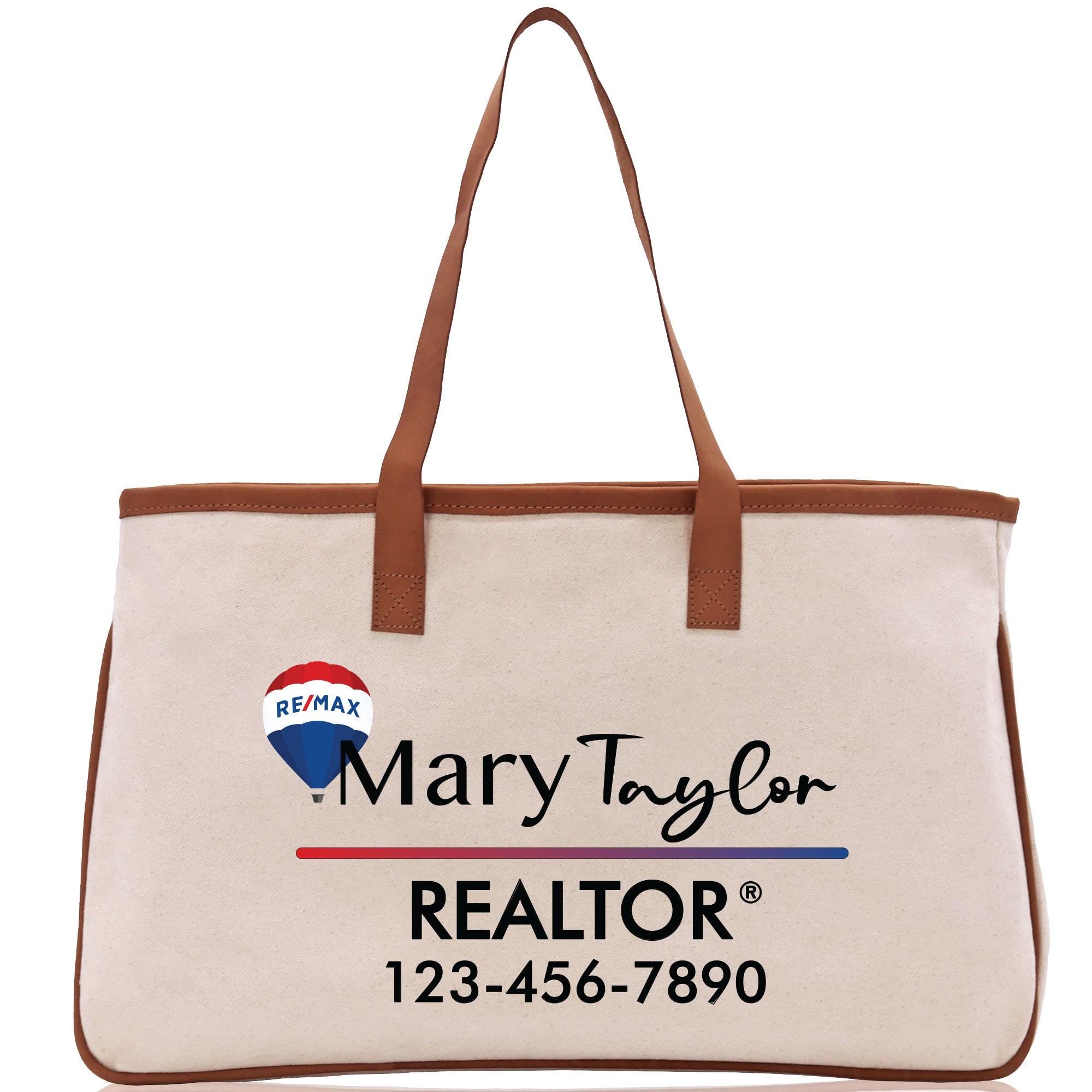 a white bag with a brown leather handle