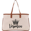 A beige canvas tote bag with a brown leather strap and a black crown logo printed on it.