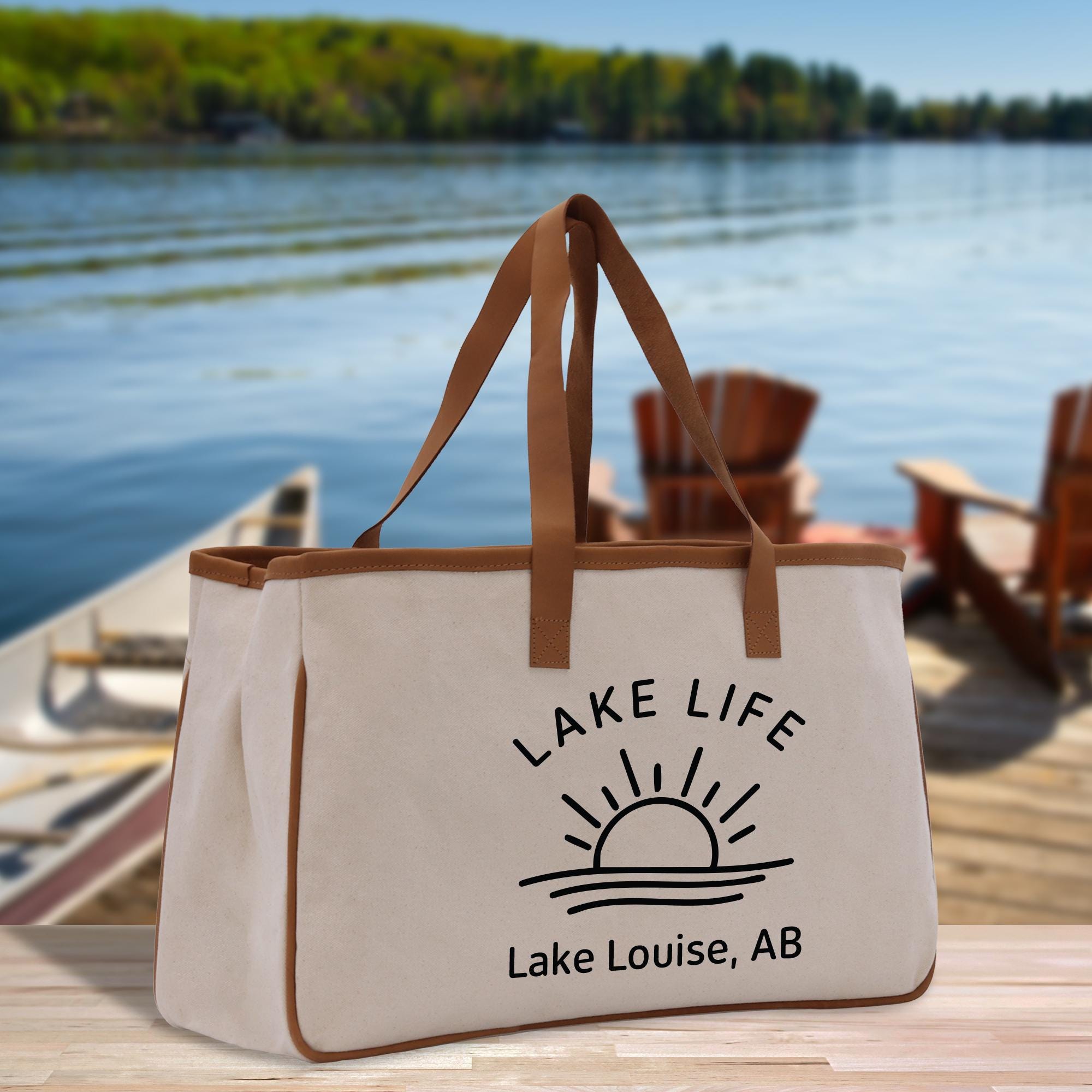 a lake life tote bag sitting on a dock