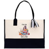 a black and white tote bag with a picture of a girl reading a book