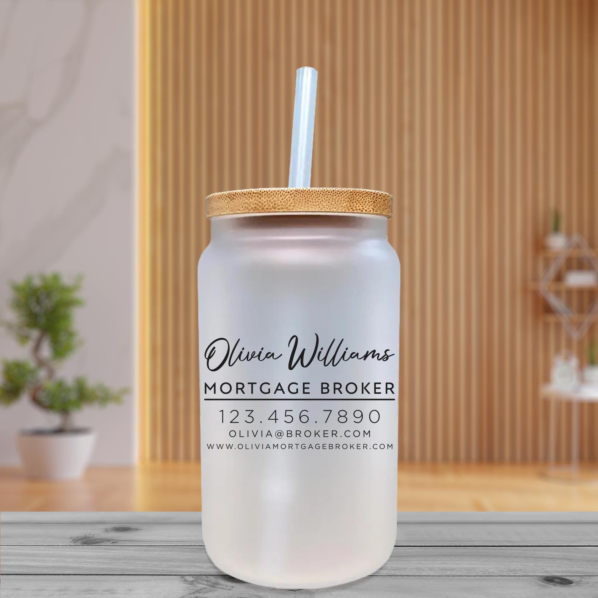 a glass jar with a straw in it on a table