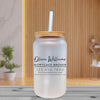 a glass jar with a straw in it on a table