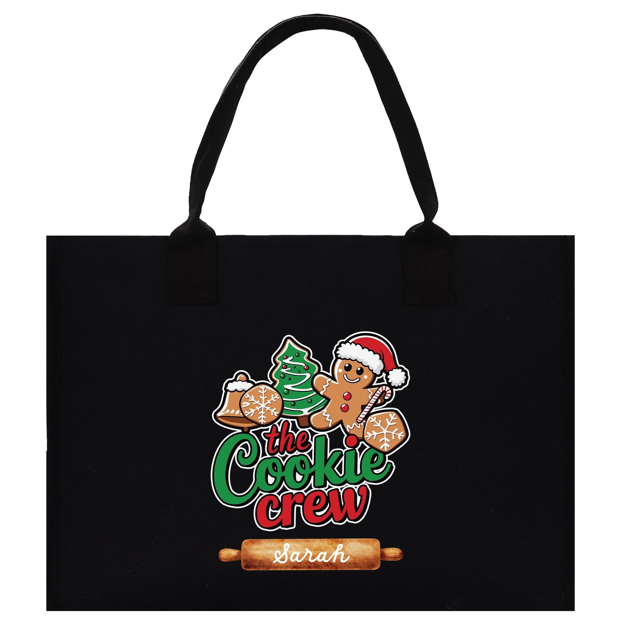 A black tote bag with a colorful graphic design featuring a gingerbread man, a Christmas tree, and the text &quot;The Cookie Crew&quot; along with the name &quot;Sarah&quot;.