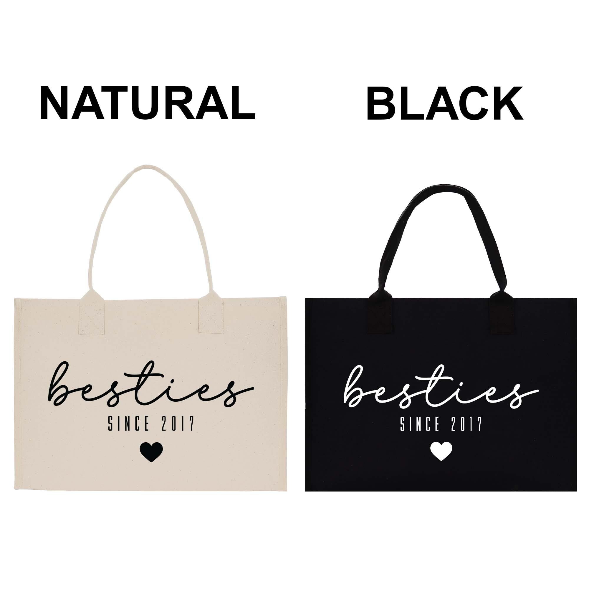two tote bags, one in natural color and the other in black, with the text &quot;besties&quot; printed on them.