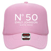 A pink trucker hat with the text "N°50 EMILY JOHNSON AUSTIN, TEXAS" printed on it.