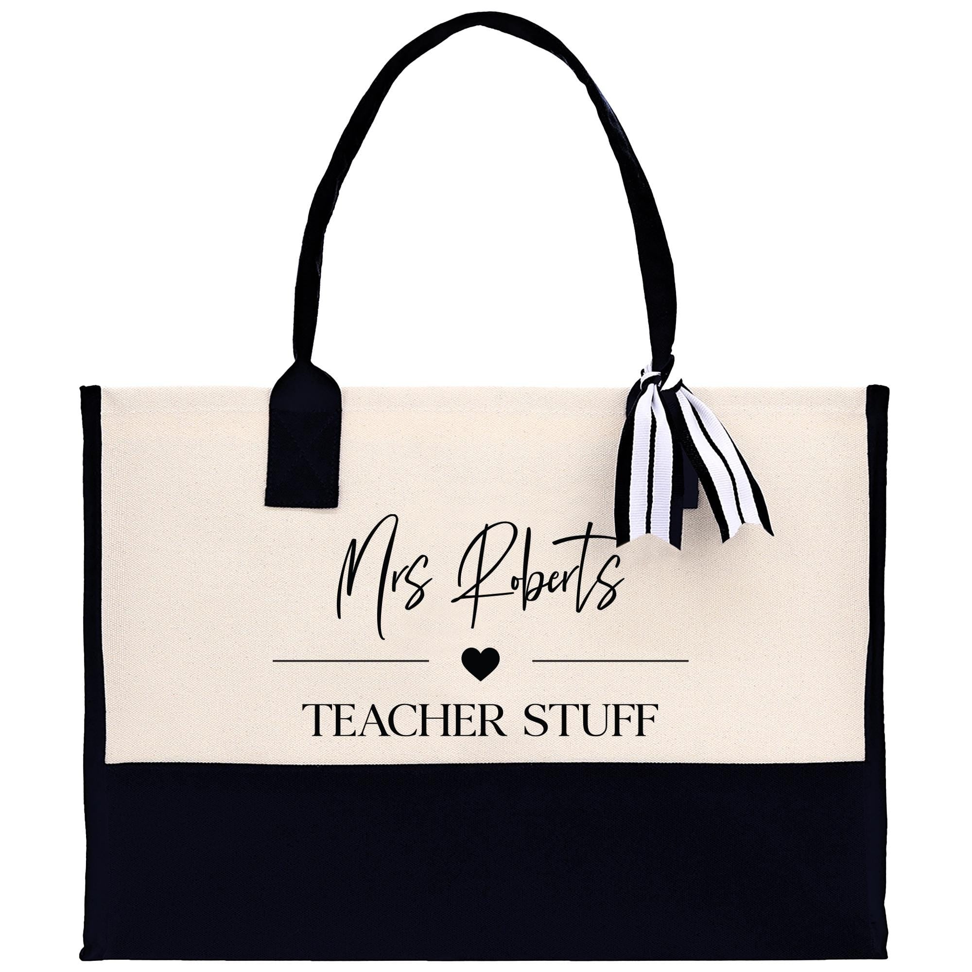 a black and white tote bag with a teacher stuff tag