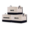 two black and white bags that say hats, scarves, and belts